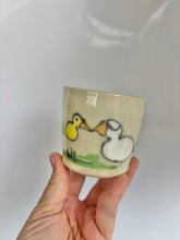 Load image into Gallery viewer, Ceramic cup with duck design held by a hand against a white background
